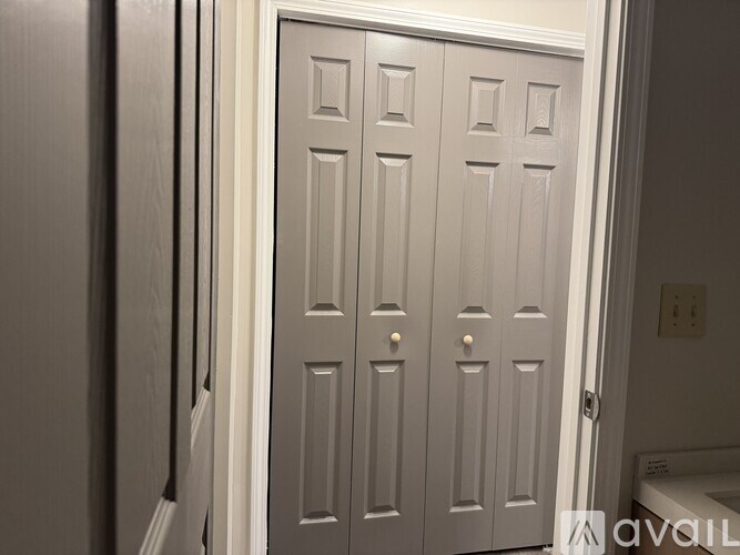 A white door with a handle and a lock.