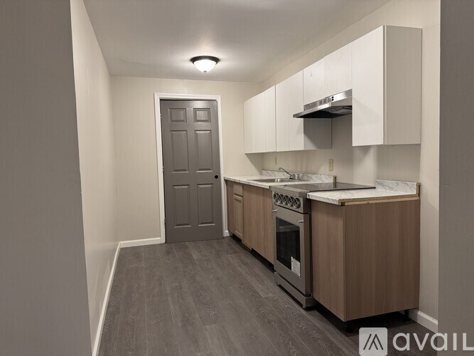 A kitchen with a stove top oven and a sink.