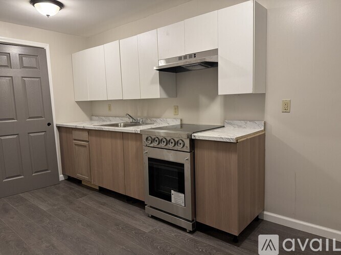 A kitchen with a stove, oven, and cabinets.