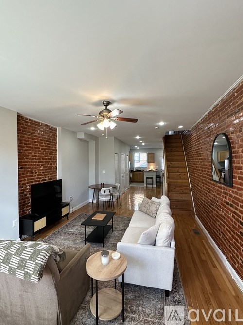 A living room with a couch, a coffee table, and a fireplace.