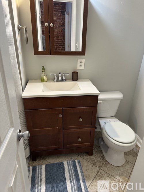 A bathroom with a white sink and a white toilet.