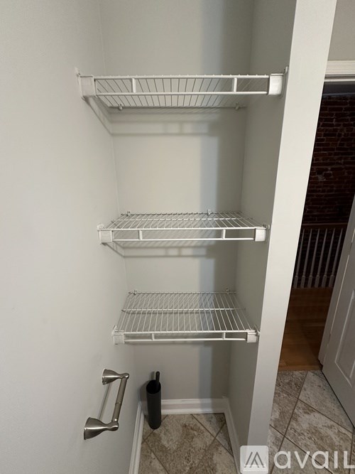 Empty white shelves in a pantry.