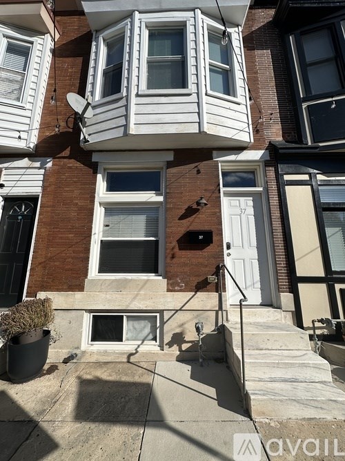 A house with a white front and a black door.