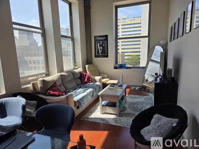 A living room with a couch, chair, and a table.