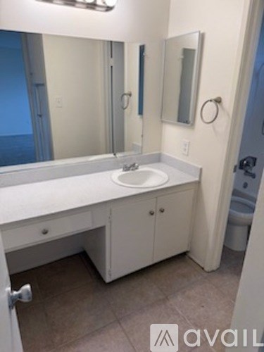A bathroom with a sink and a mirror.
