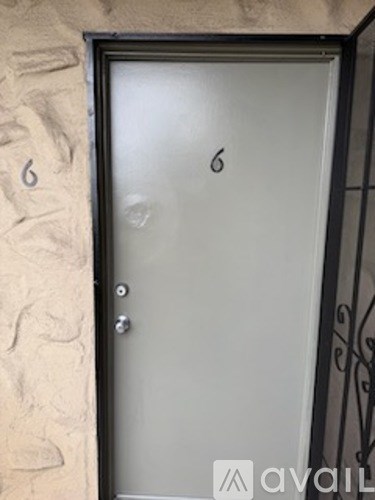 A metal door with a number 6 on it.