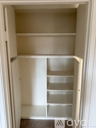 A white empty cabinet with shelves is open.