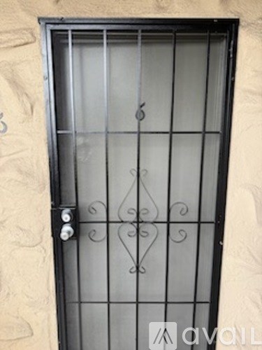 A window with a metal grill and a handle.