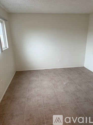 A room with a tile floor and a window.