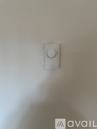 A white light switch on a wall.
