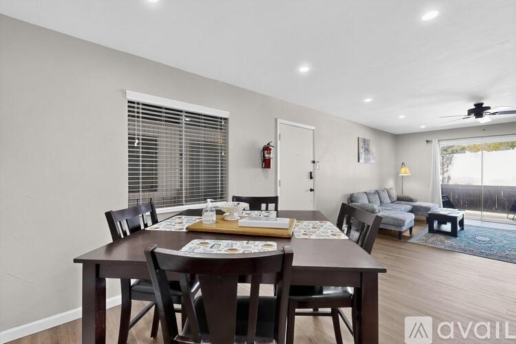 A dining room with a wooden table and chairs.