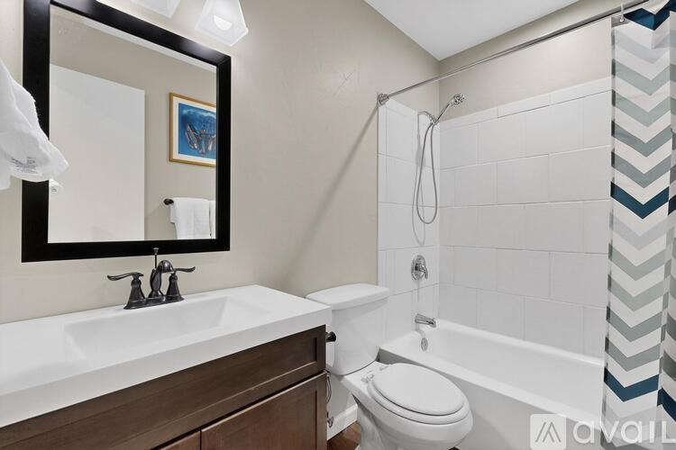 A bathroom with a white sink and a white toilet.