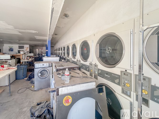 A laundry room with washers and dryers.
