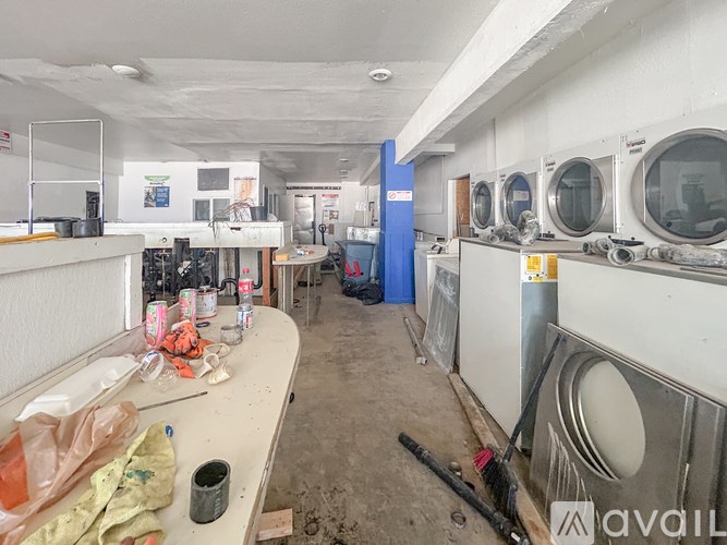 A dirty workshop with lots of tools and equipment.