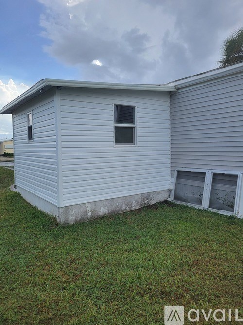 A grey house with a window and a door.