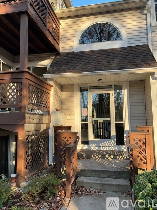 A house with a balcony and a door with a glass panel.