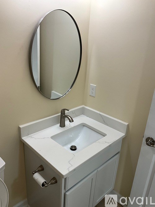 A bathroom with a sink and a mirror.