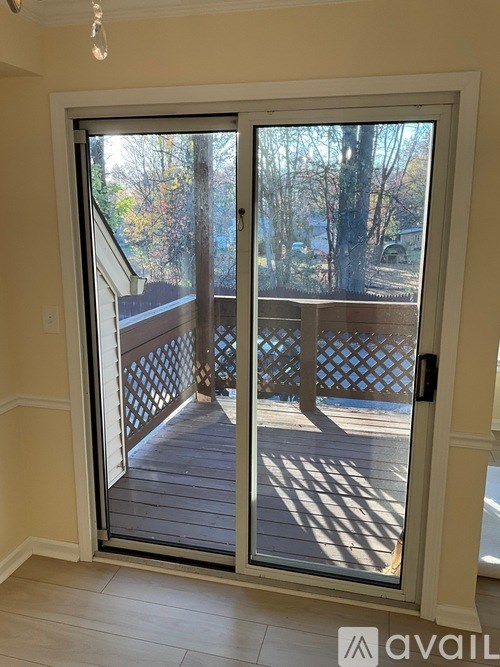 A glass door with a wooden deck outside.
