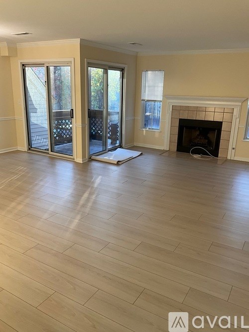 A living room with a fireplace and sliding glass doors.