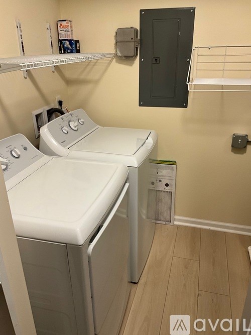 A small laundry room with a washer and dryer.