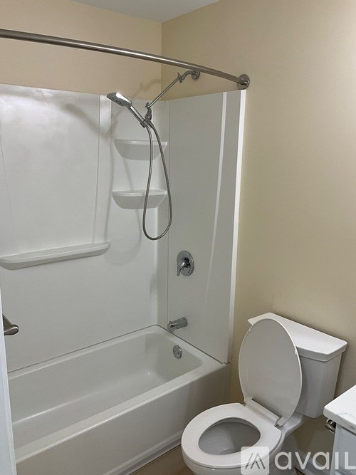 A white toilet is next to a white bathtub in a bathroom.