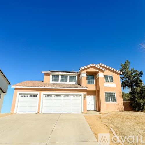 A two-story house with a garage is available for sale.