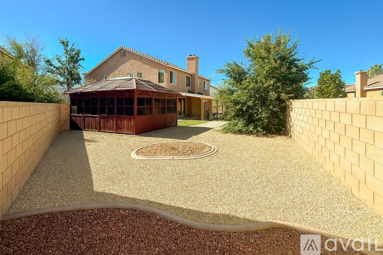 A house with a brown roof and a brown fence is for sale.