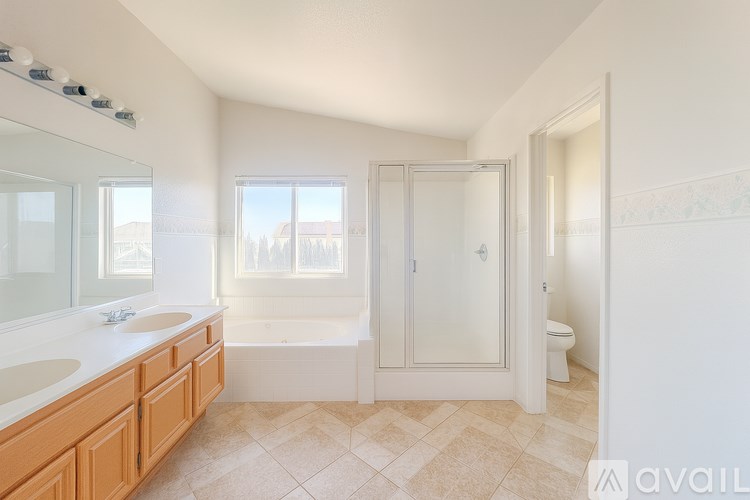 A bathroom with a tub, sink, and toilet.