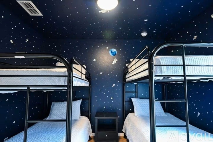 A room with bunk beds and a ceiling decorated with stars.