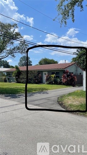 A residential street with houses and trees.