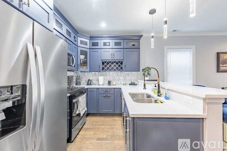 A kitchen with a stainless steel refrigerator and blue cabinets.