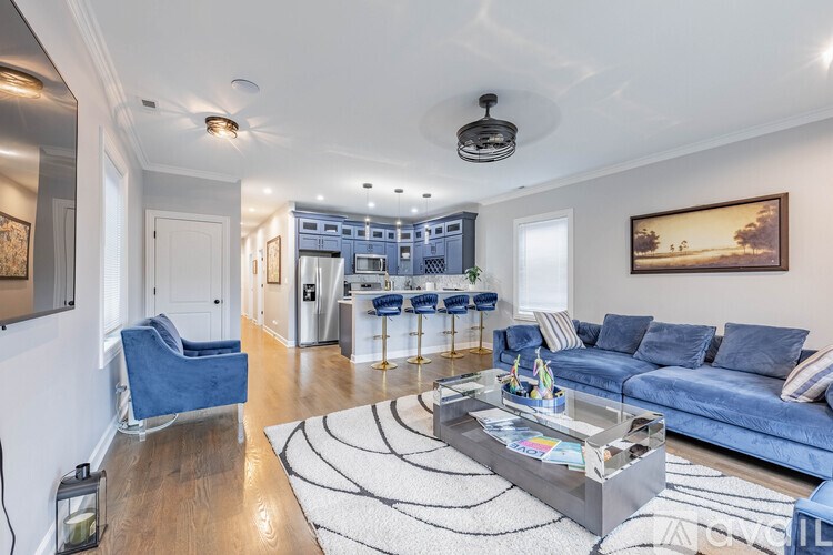 A living room with a blue couch and a coffee table.