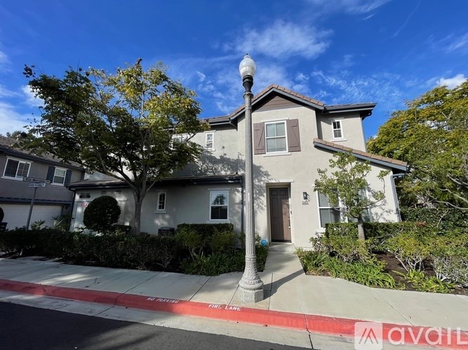 A house with a red and white striped curb in front of it.