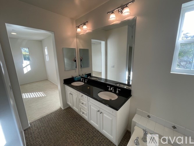 A bathroom with two sinks and a large mirror.