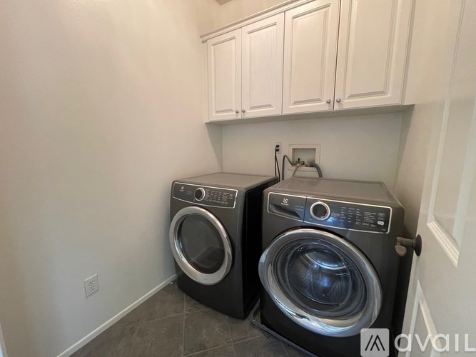 Two front load washing machines in a laundry room.