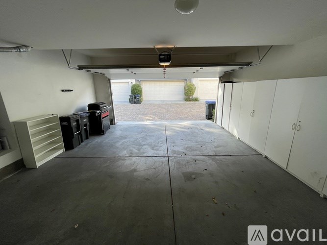 A spacious garage with a concrete floor and white walls.