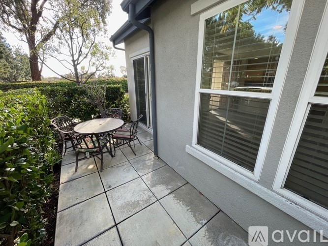 A patio with a table and chairs is shown.
