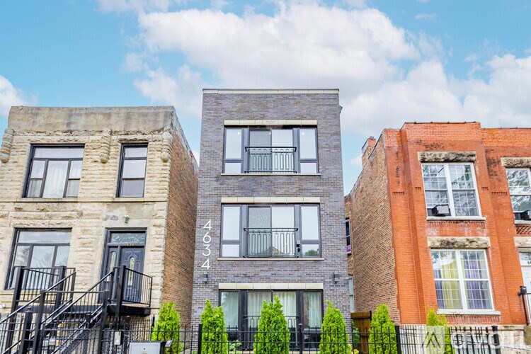 Three buildings with balconies and windows are shown in the image.
