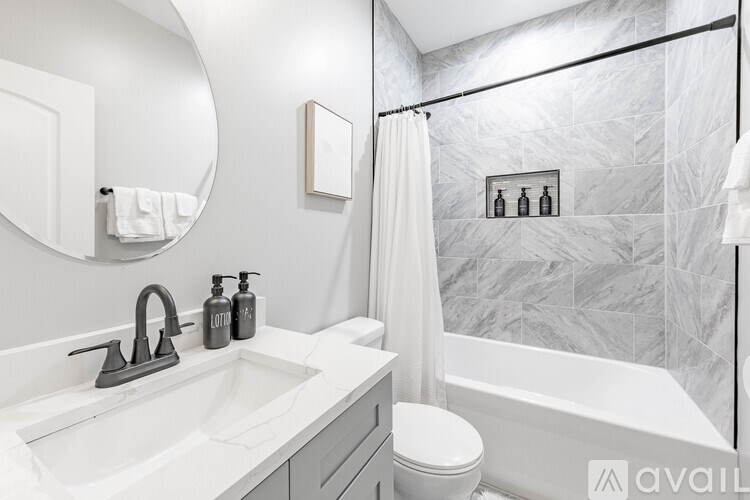 A bathroom with a white sink, toilet, and bathtub.
