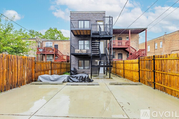 A multi-story building with a balcony and a staircase in the foreground.
