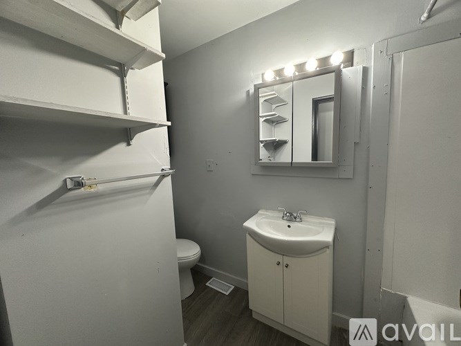 A bathroom with a sink, toilet, and medicine cabinet.