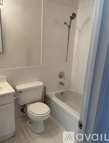 A white toilet and sink in a bathroom.
