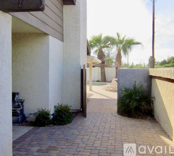 A patio area with a doorway leading to a pool.