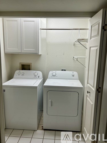 A small laundry room with a washer and dryer.