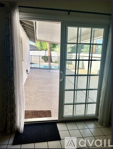 A view of a patio through a sliding glass door.