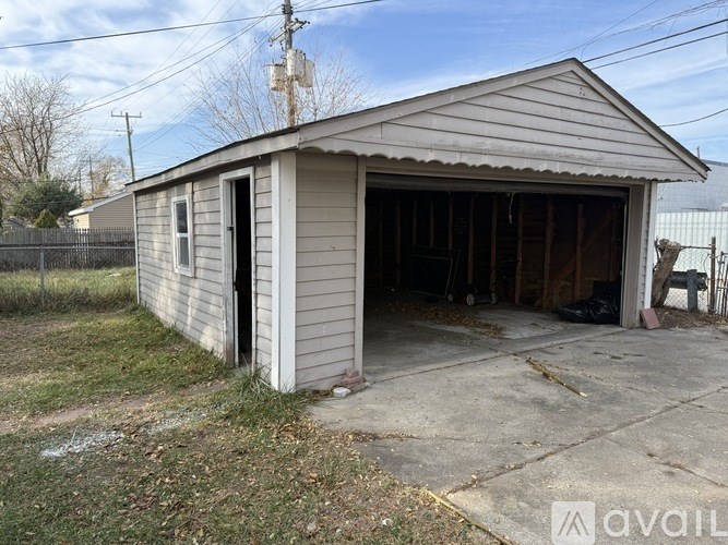 A garage with a door open and a car inside.