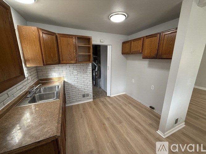 A kitchen with wooden cabinets and a sink.