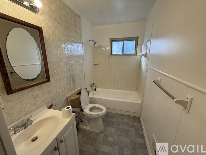 A bathroom with a toilet, sink, and bathtub.