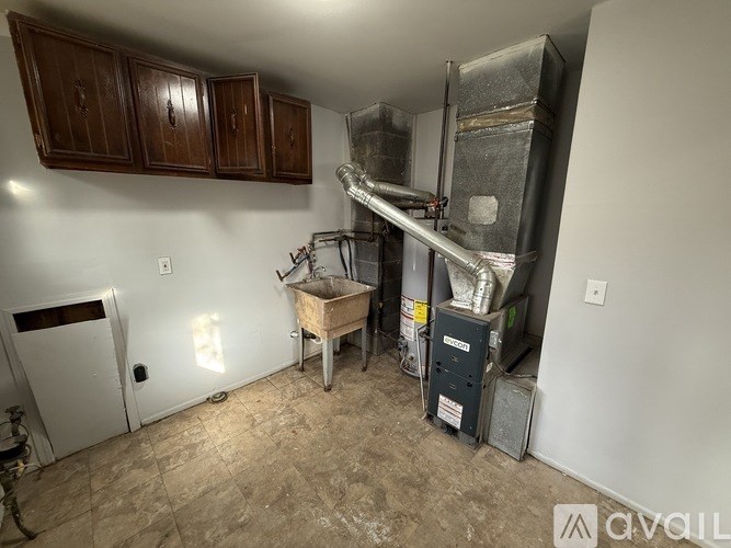 A room with a furnace and a table in it.