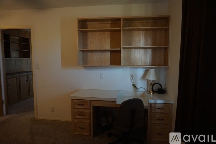 A room with a desk and a chair.